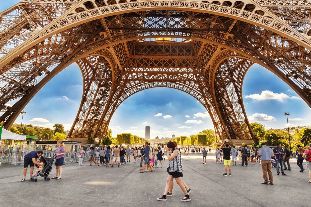 Tourists Walking under Eiffel Tower