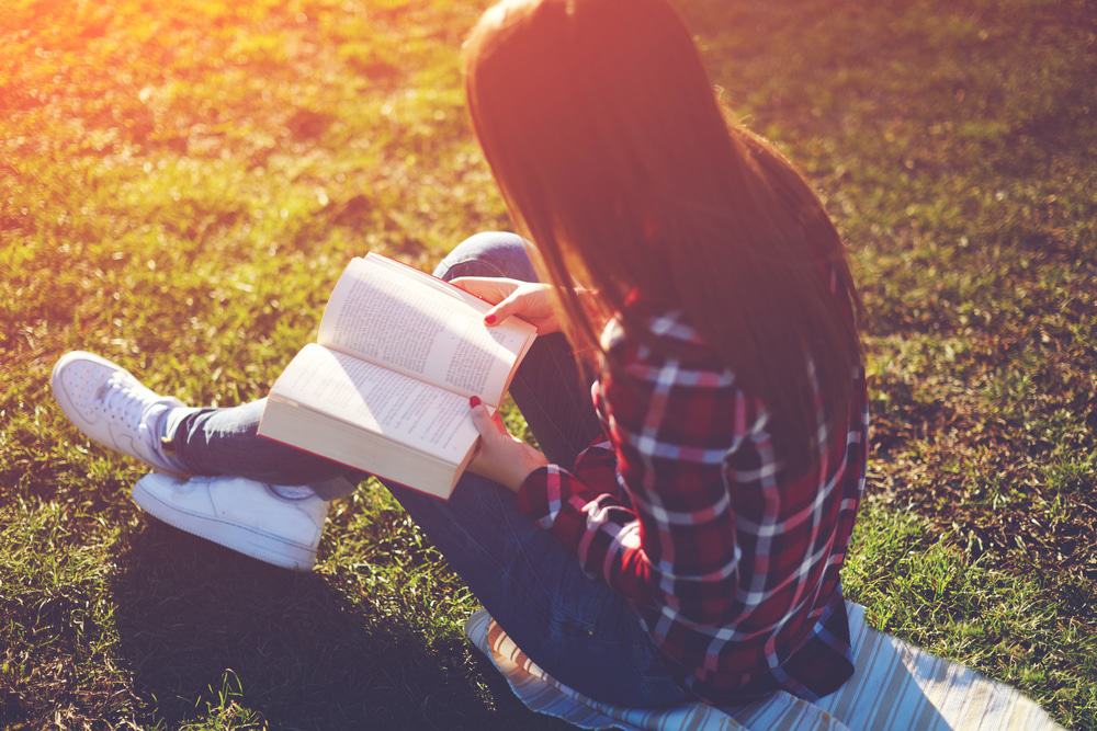 Reading A Book In The Park