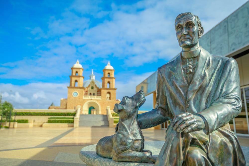 Statue Of Monsignor John Hawes Next To The Monsignor Hawes Heritage Museum
